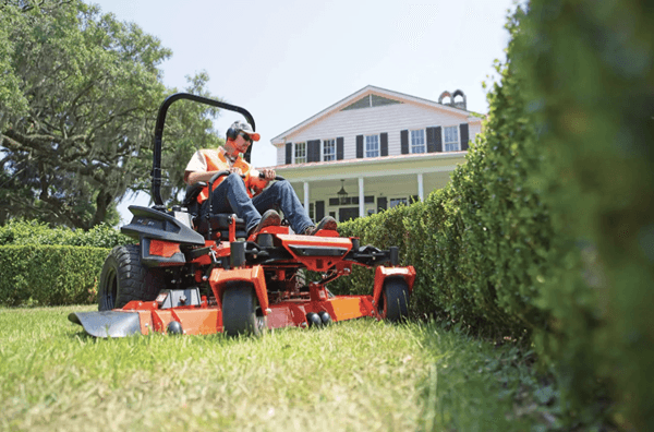 Man mowing close to bushes