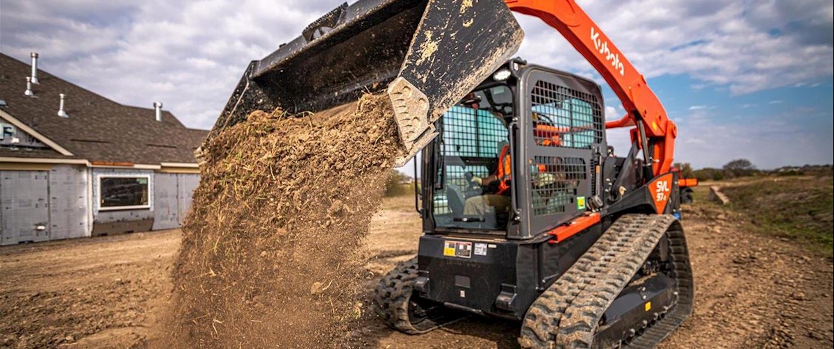 A Kubota SVL97-2s drops dirt in front of the camera